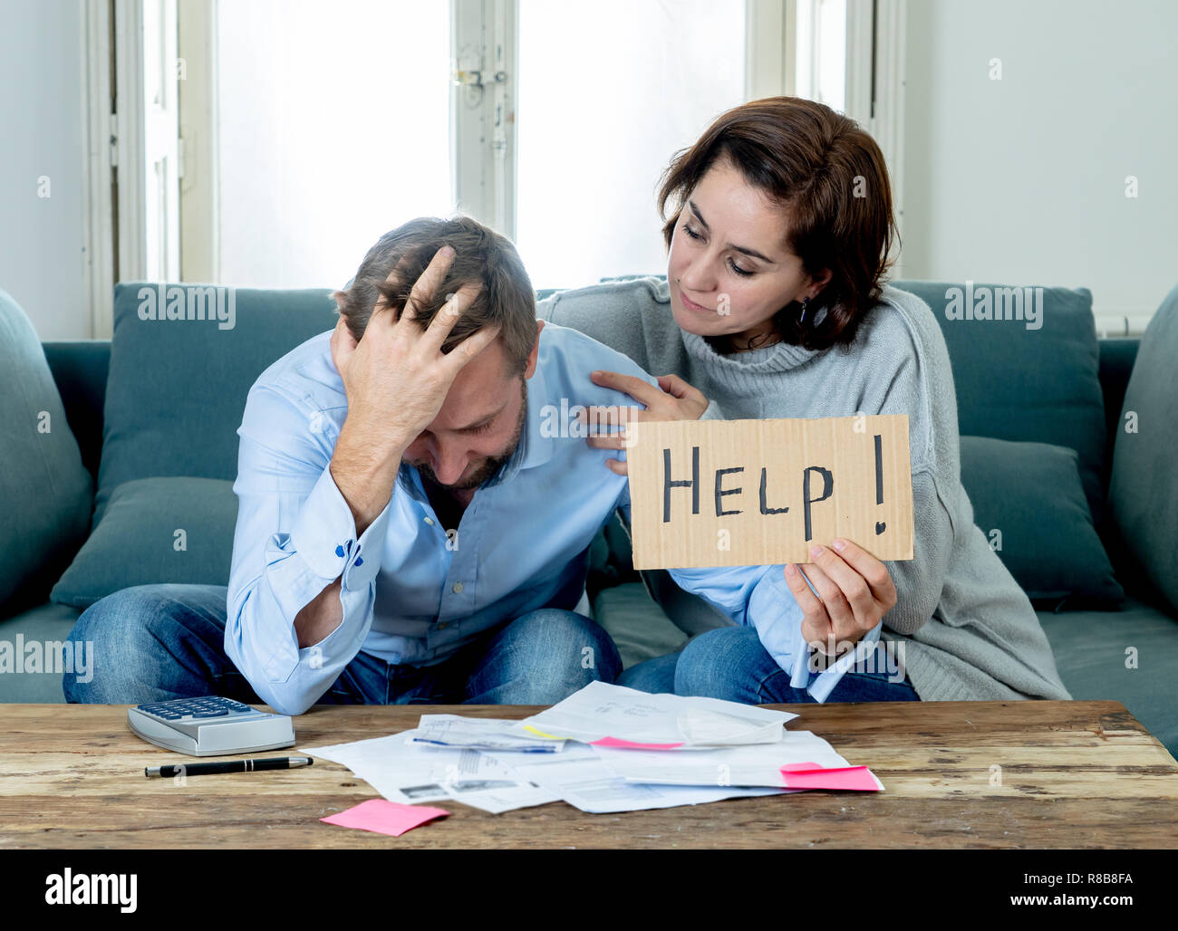 Stressed young couple accounting home finance paying bills mortgage bank statements and expenses feeling desperate having so many debts in bad financi Stock Photo