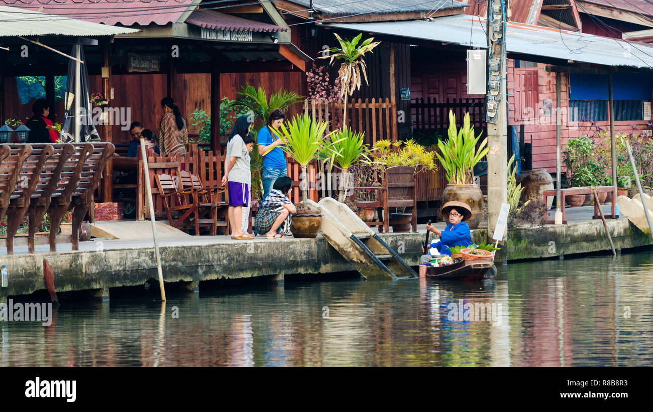 Thai lady rowing Amphawa canals to sell food, Amphawa, Thailand Stock Photo