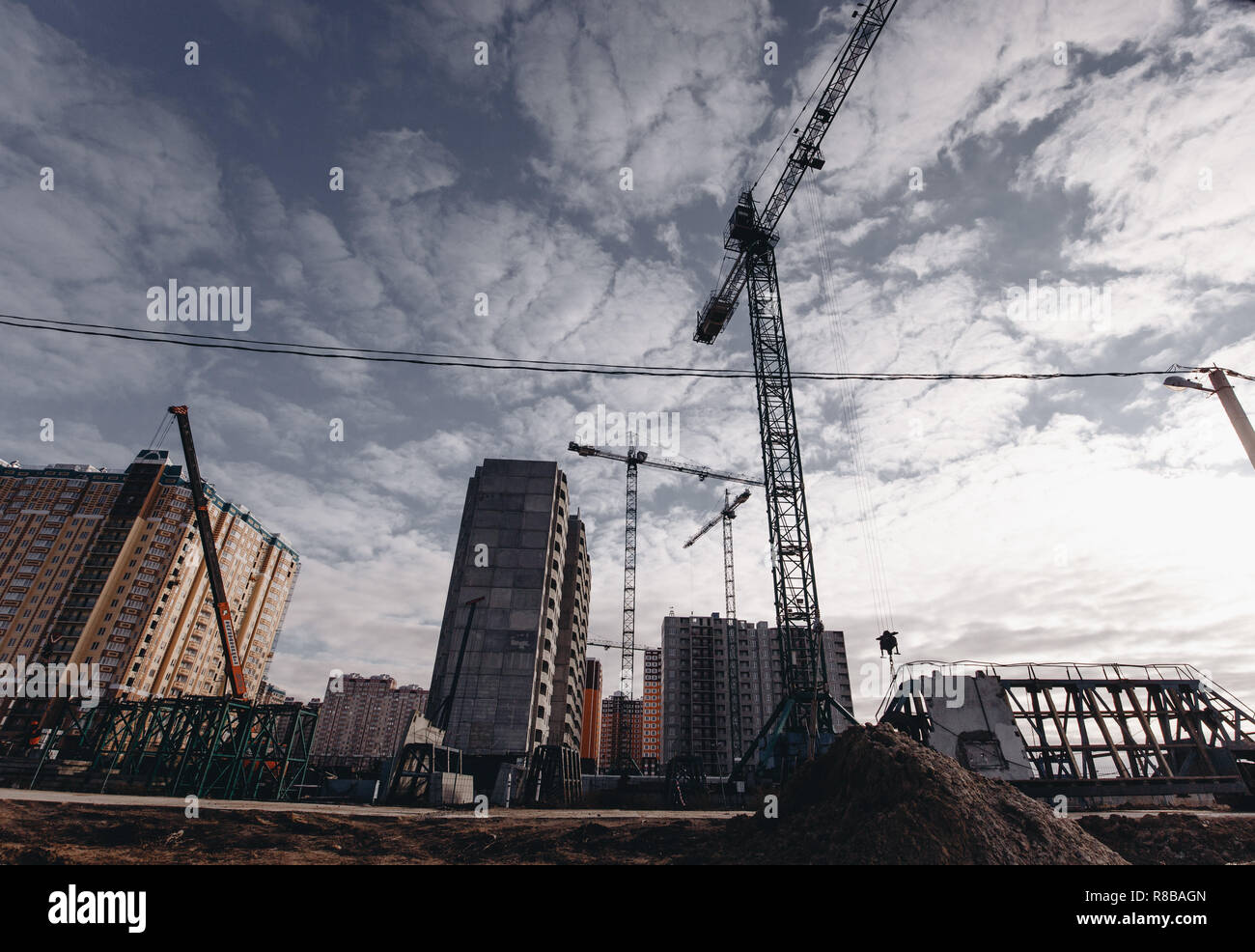 View of the construction site with cranes and high-rise residential buildings. Stock Photo