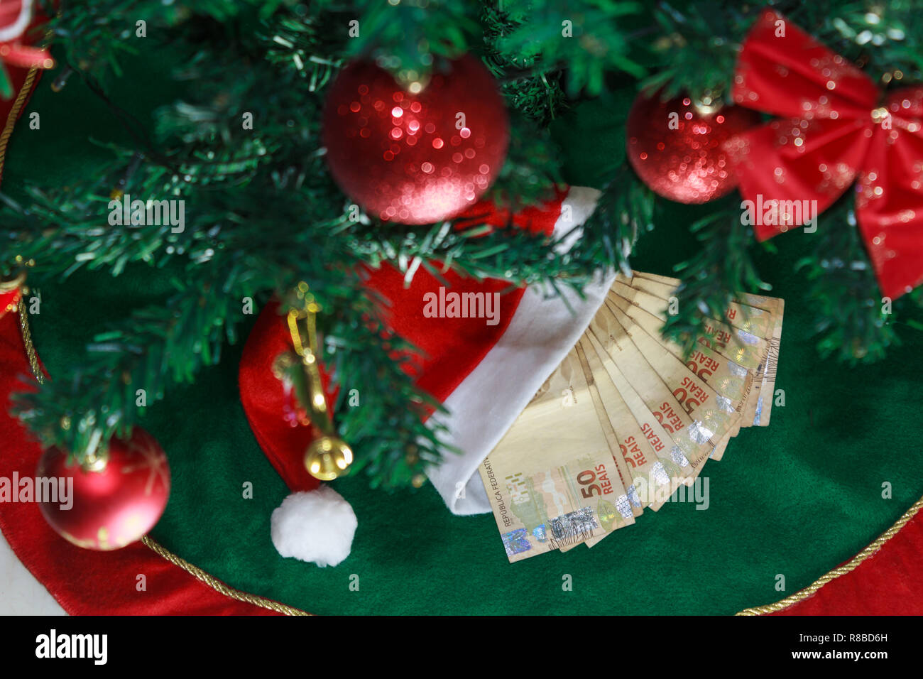 Santa cap with money brazilian. Money for Christmas gifts or gift money. Christmas Concept. Stock Photo