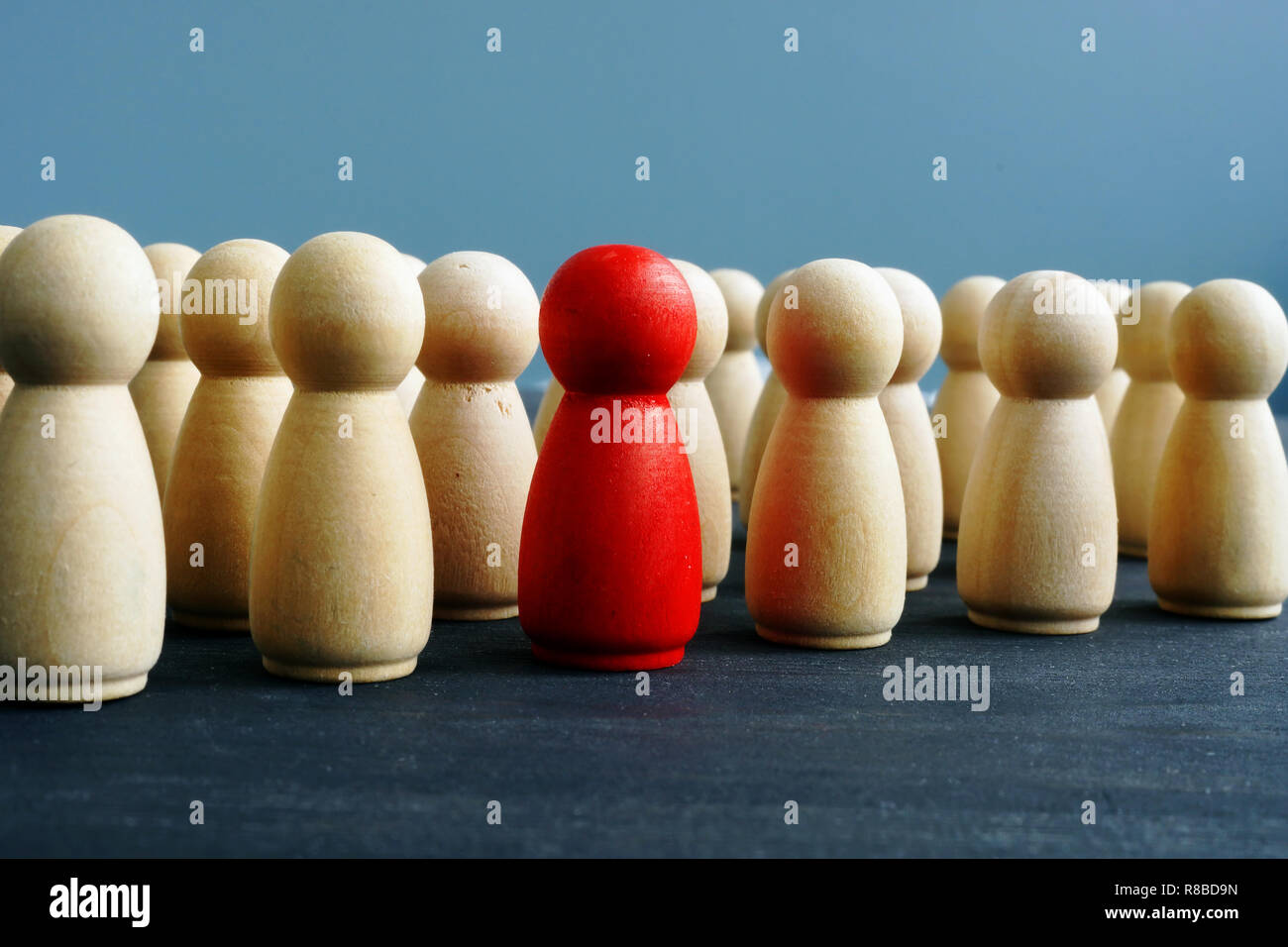 Difference, dissimilarity and distinctness concept. Wooden figures on a desk. Stock Photo