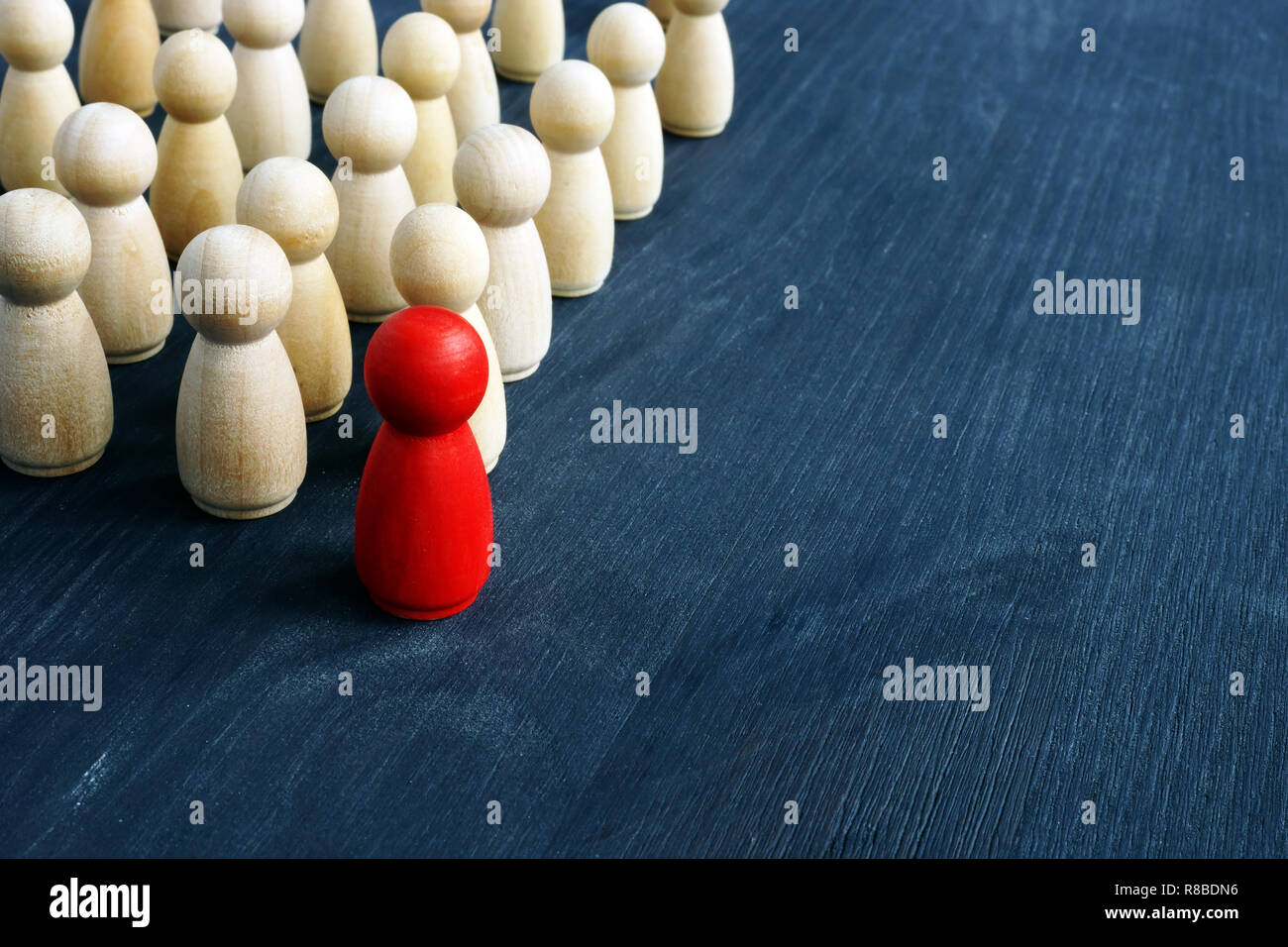 Leadership and management in business. Small figures on the desk. Stock Photo