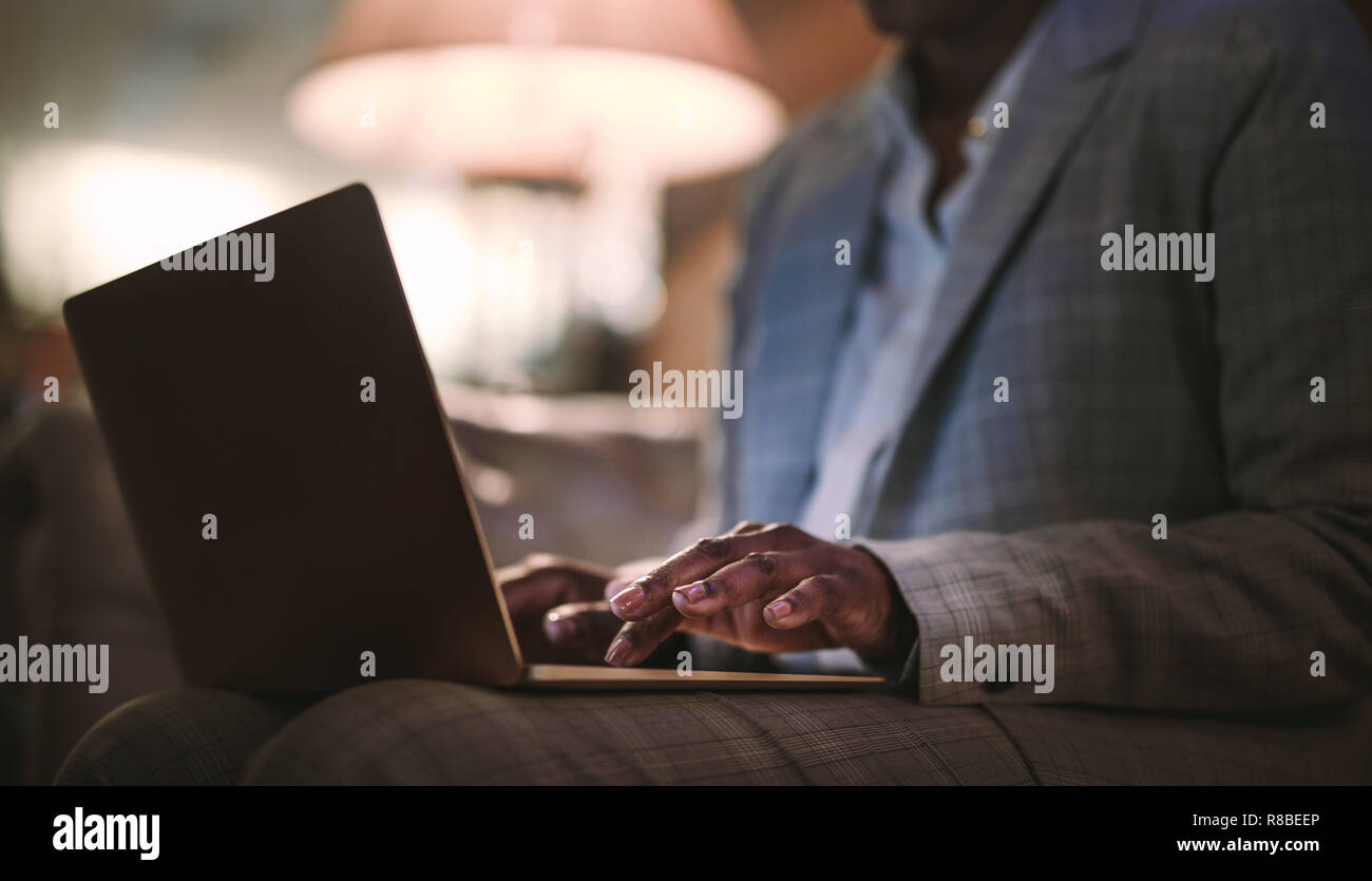 Close up of woman hands using laptop. Businesswoman working on laptop computer at hotel lobby. Stock Photo