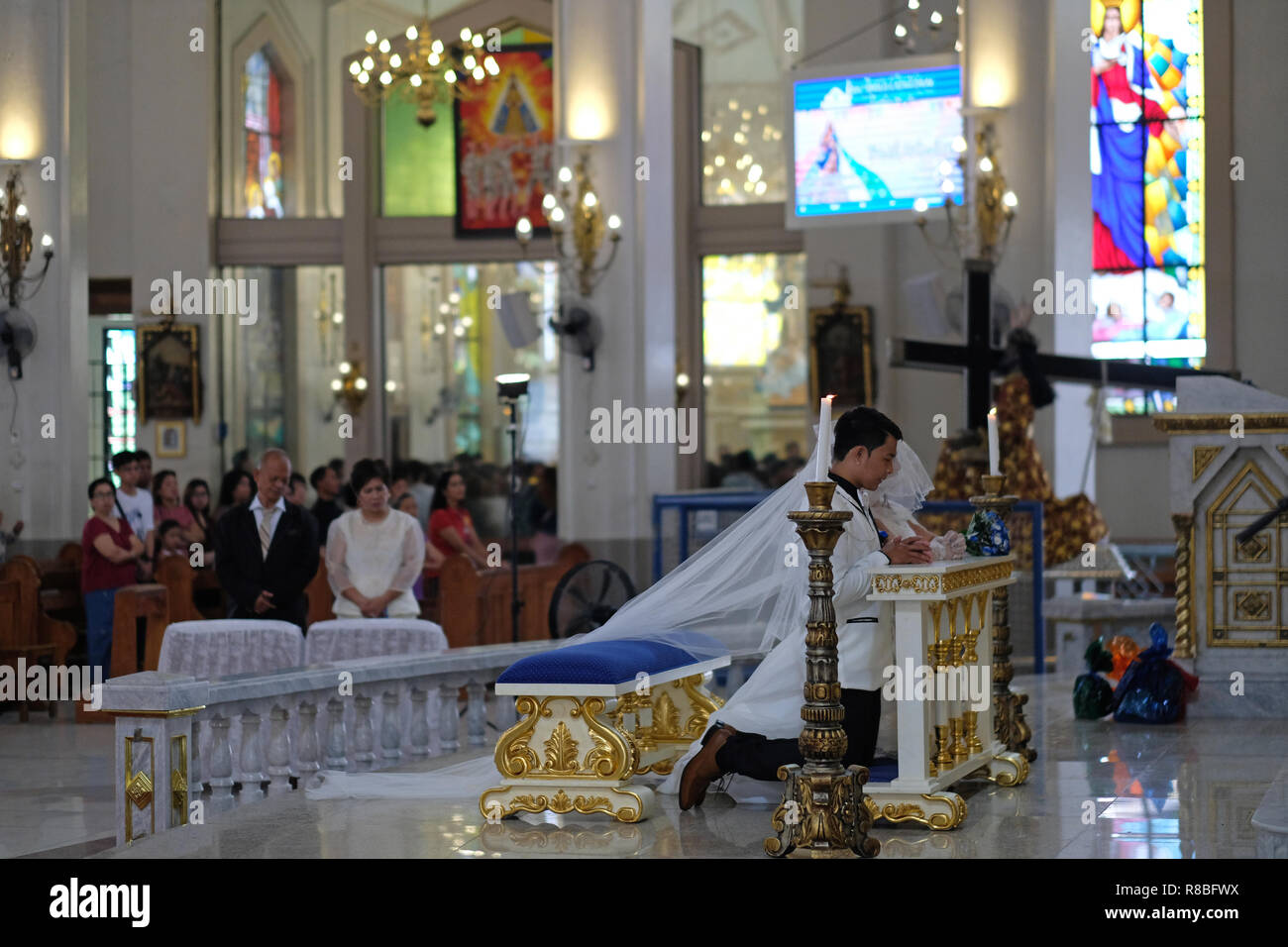 Wedding ceremony inside the Roman Catholic Antipolo Cathedral or National Shrine of Our Lady of Peace and Good Voyage located in the city of Antipolo, in the province of Rizal in the Philippines. Stock Photo