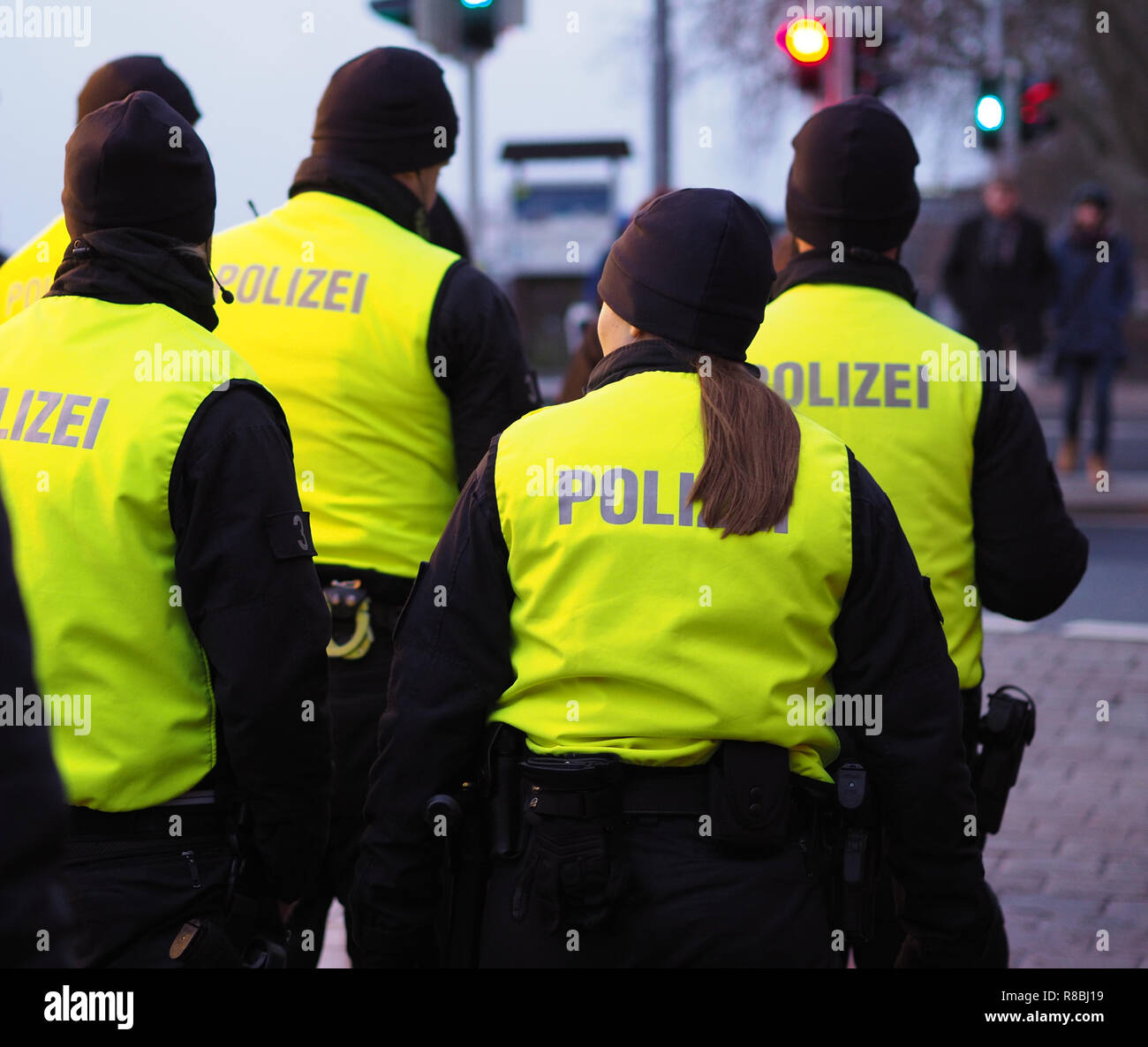 Bremen, Germany - Group of police officers in black uniforms and hi-viz vests patrolling the christmas market Stock Photo