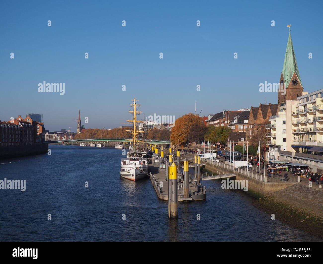 Bremen, Germany - View of the river Weser and the historic Schlachte waterfront with the spire of St. Martini church Stock Photo