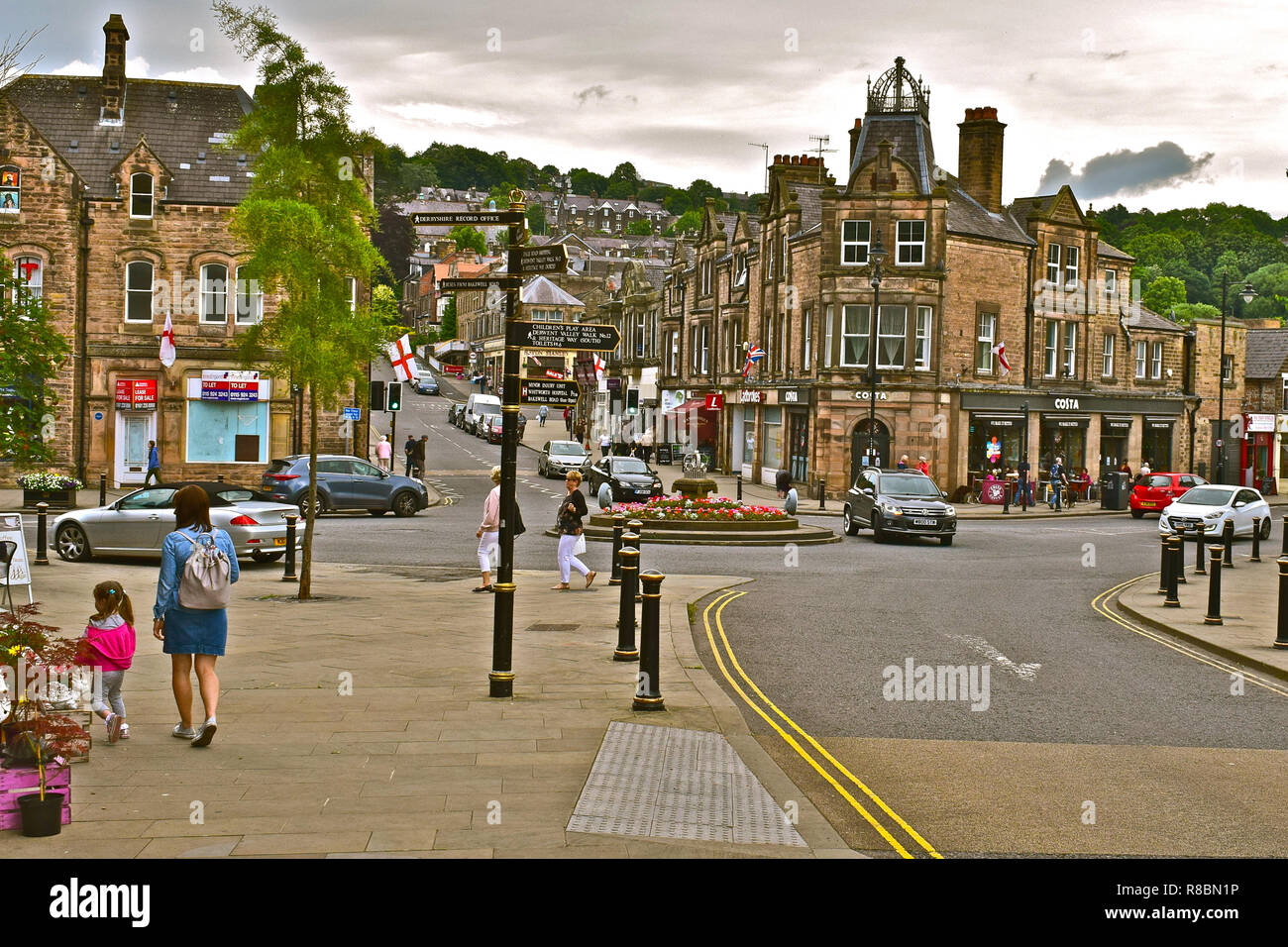 Pretty floral displays and attractive old buildings enhance this street view of the historic old Spa town centre of Matlock in Derbyshire. Stock Photo