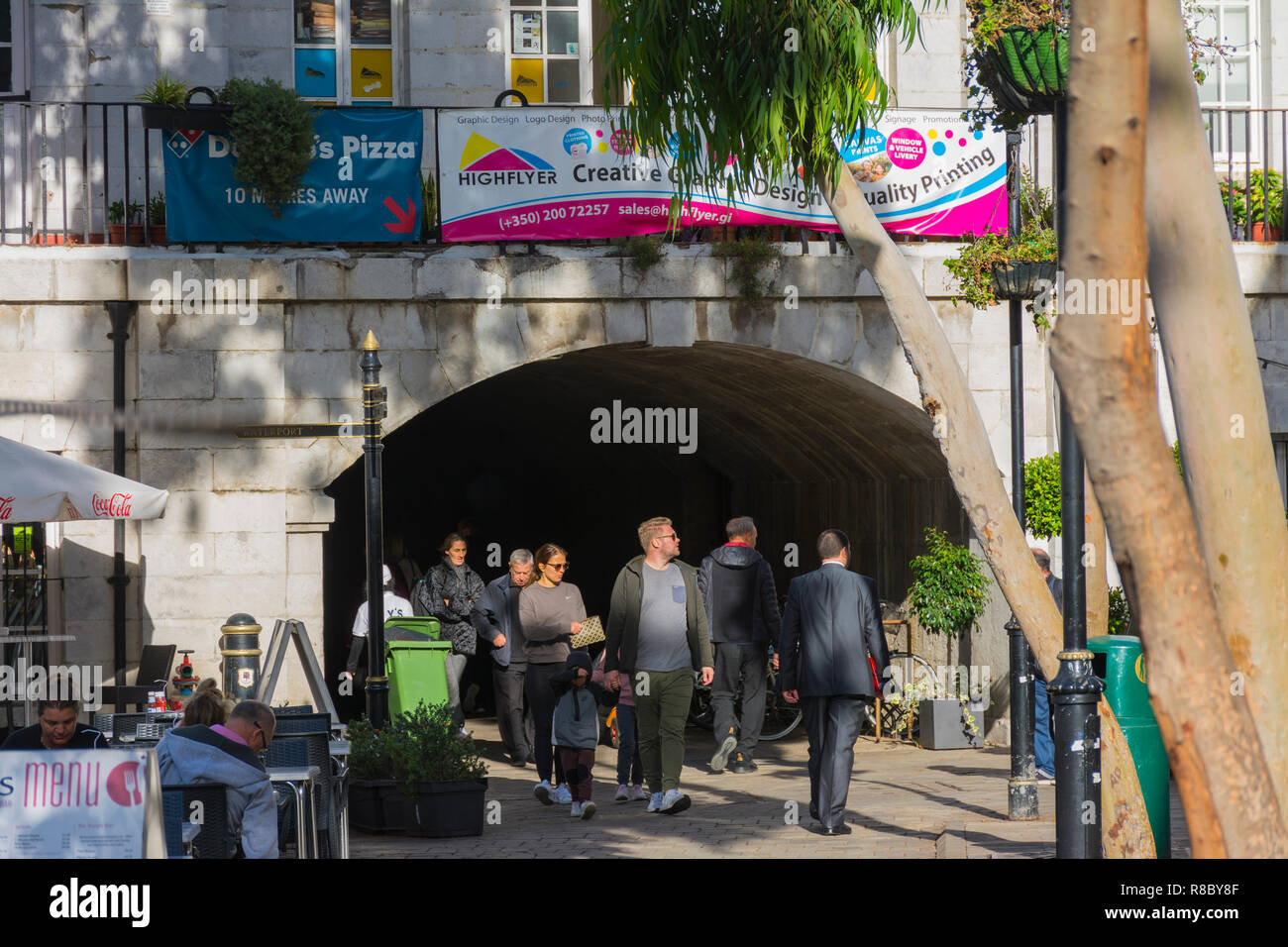 GIBRALTAR, GREAT BRITAIN, november 5, 2018 - Gate of Landport tunnel at Grand Casemates Square, place with a lot of bar terrace and street life Stock Photo