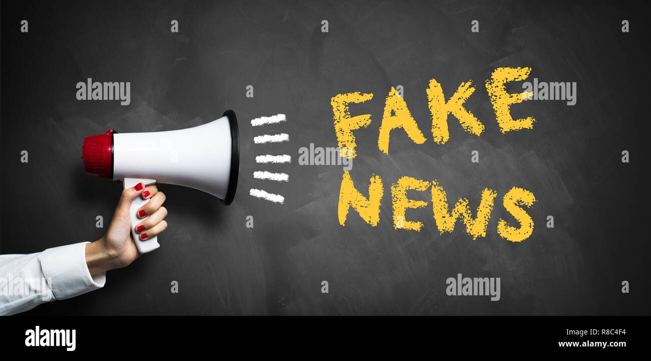 hand with megaphone and the message "fake news Stock Photo - Alamy