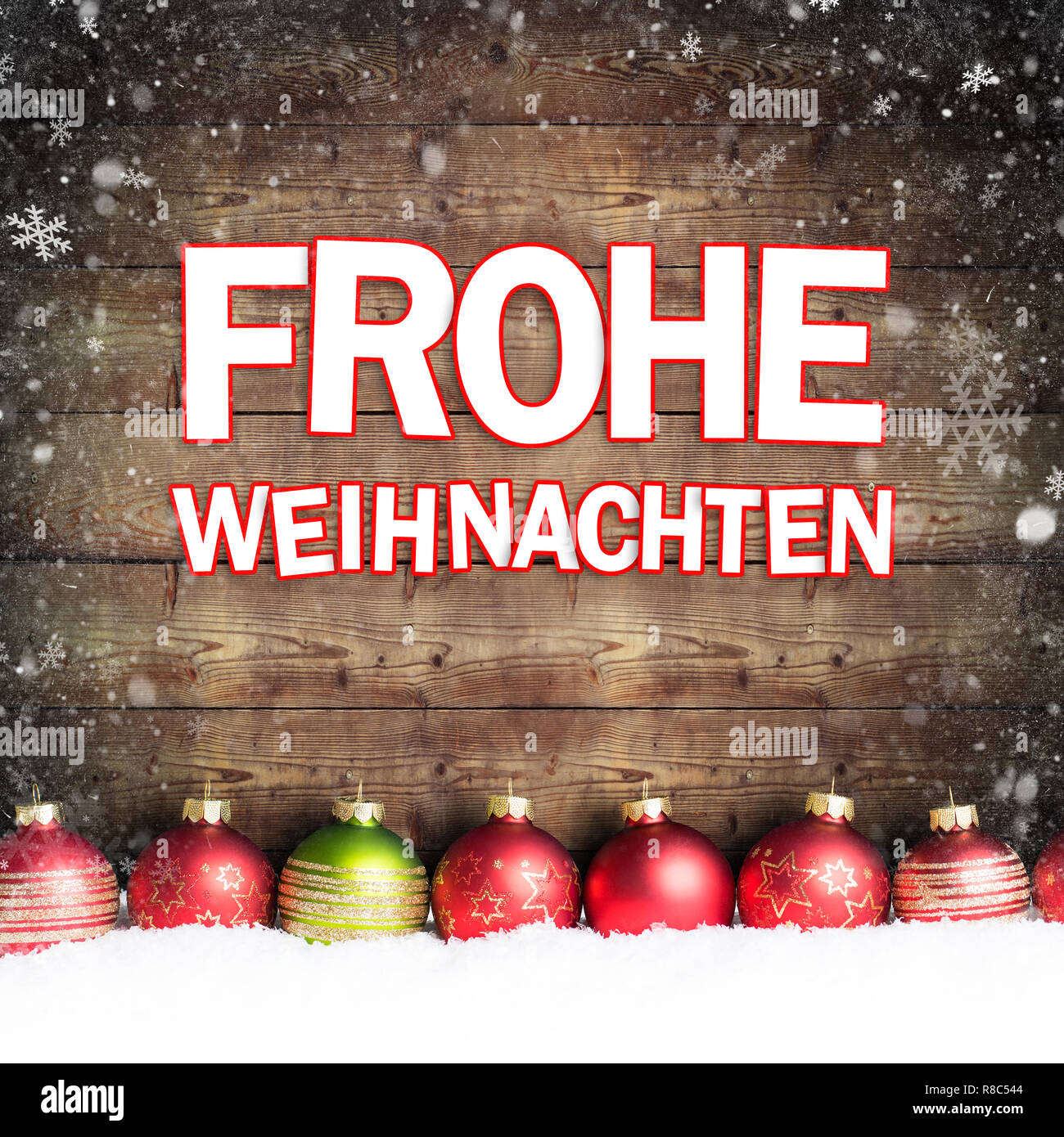 christmas ball in the snow with merry christmas greeting (in German