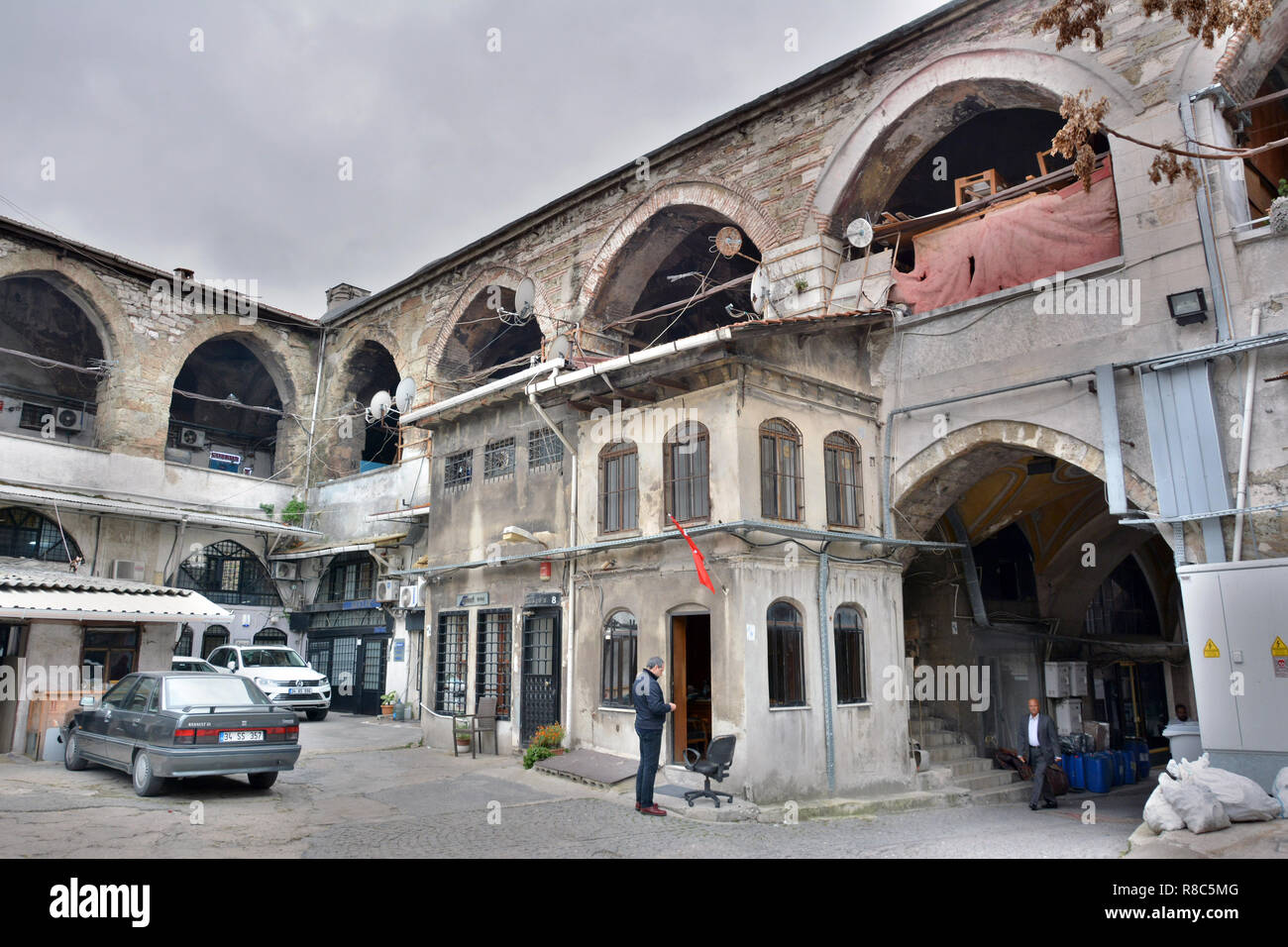 Istanbul, Turkey - November 6, 2015. Courtyard of Vezir han in Istanbul, with people and cars. This caravanserai was built between 1659 and 1660. Stock Photo