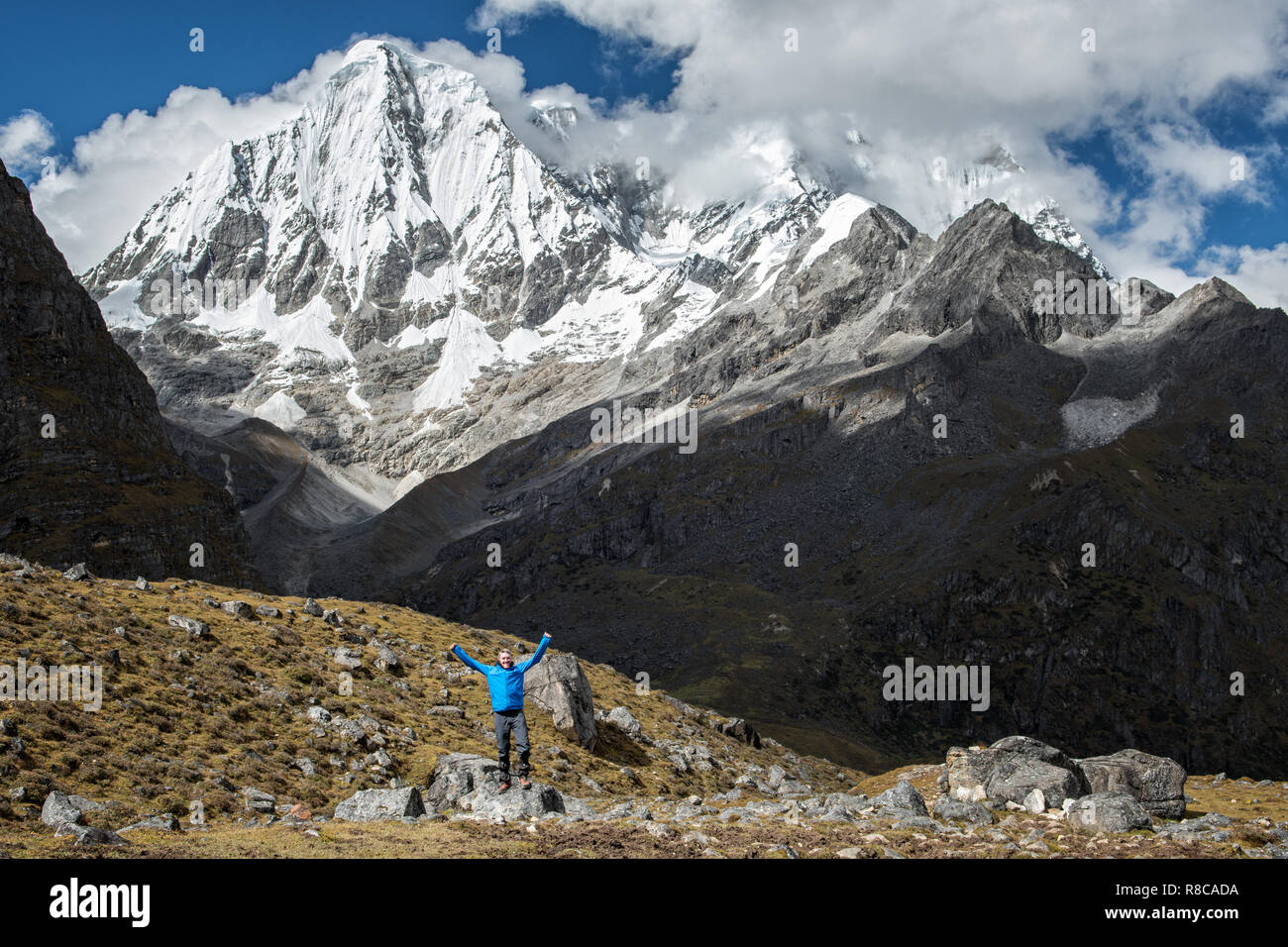 Happy trekker at the foot of Gangchhenta (Great Tiger Mountain), Gasa District, Snowman Trek, Bhutan Stock Photo