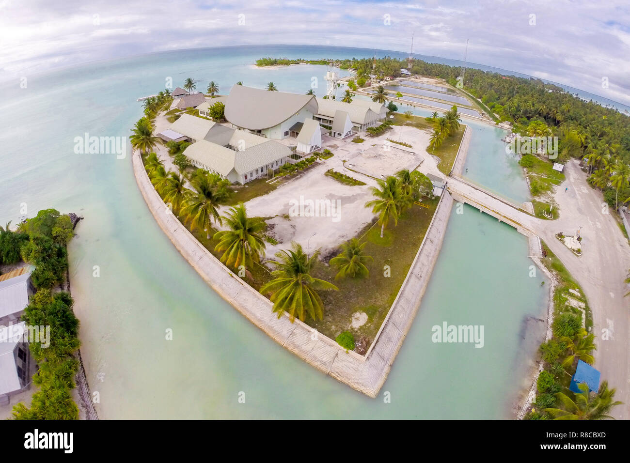 Maneaba ni Maungatabu (Parliament of Kiribati) building on motu in an atoll's lagoon, aerial view. House of Assembly, Ambo, South Tarawa, Kiribati, Gi Stock Photo