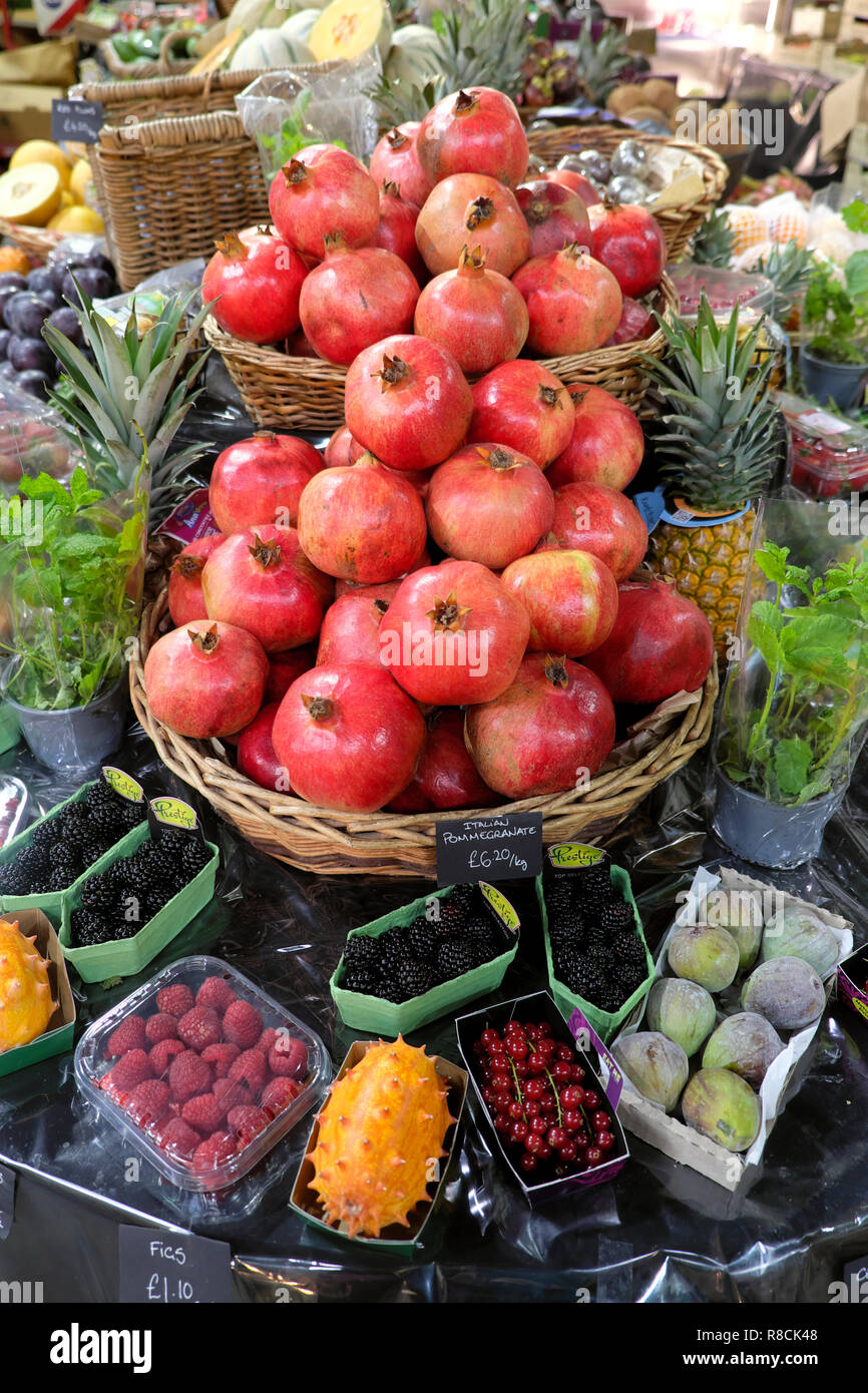Pomegranates and various fruits on a Borough Market stall in autumn November South London England UK   KATHY DEWITT Stock Photo