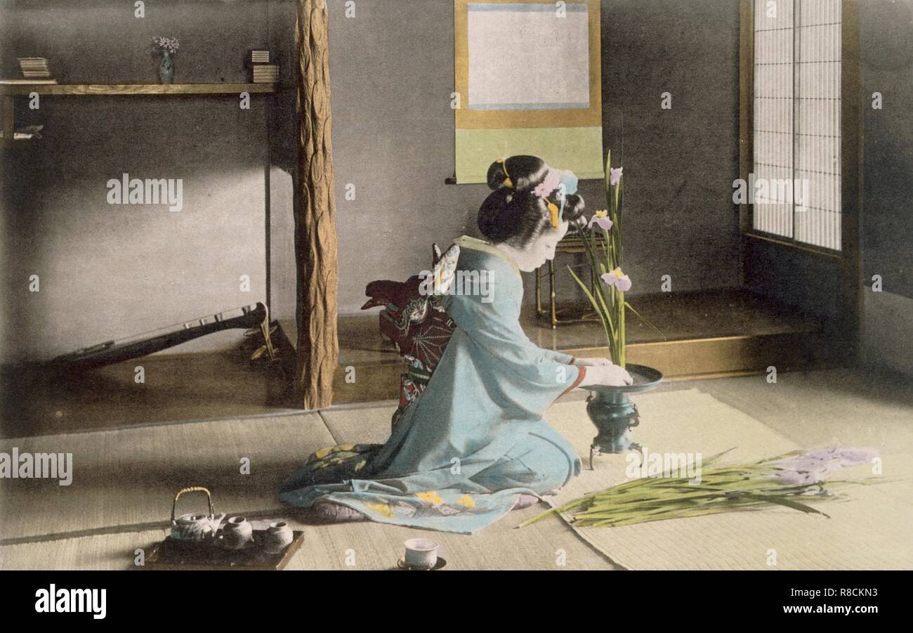 Girl arranging flowers, 1890's. Creator: Japanese Photographer (19th Century). Stock Photo