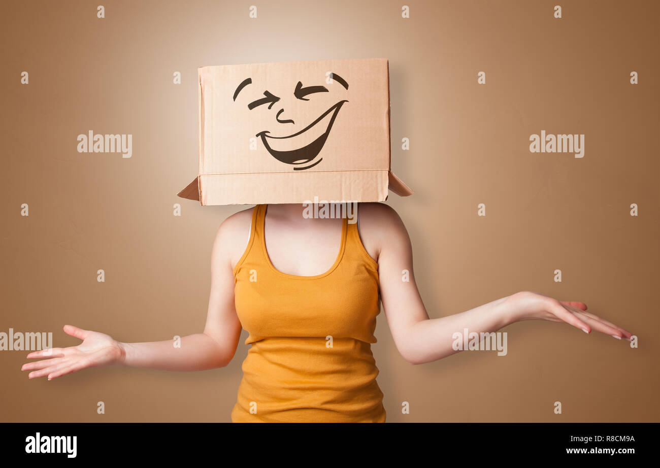 Young girl standing and gesturing with a cardboard box on her head