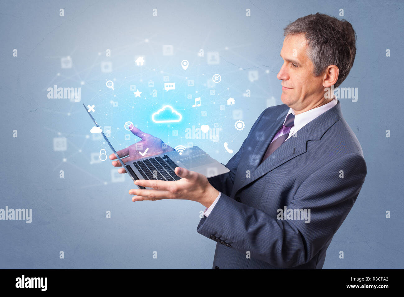 Man holding laptop projecting notifications, symbols and information