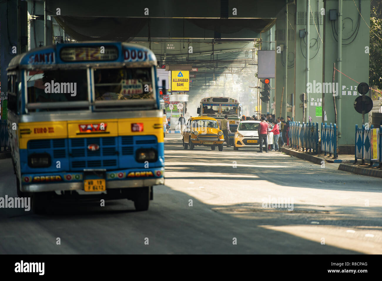 Some Ambassador cab taxi, buses and people through the streets of Kolkata. Stock Photo
