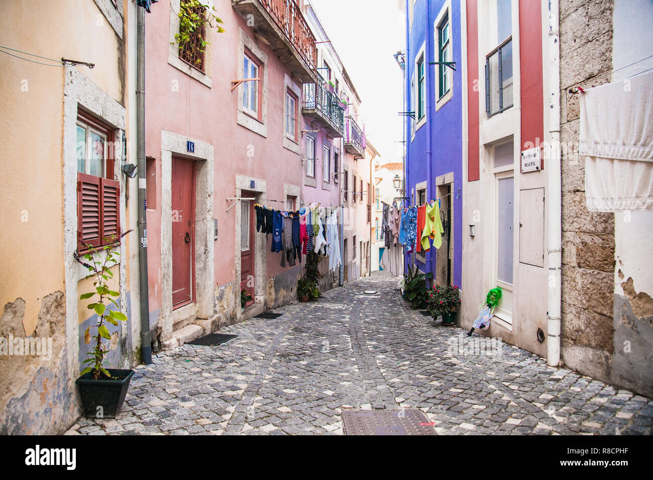 Narrow street of the traditional old district of the Portuguese capital of Lisboa. Stock Photo