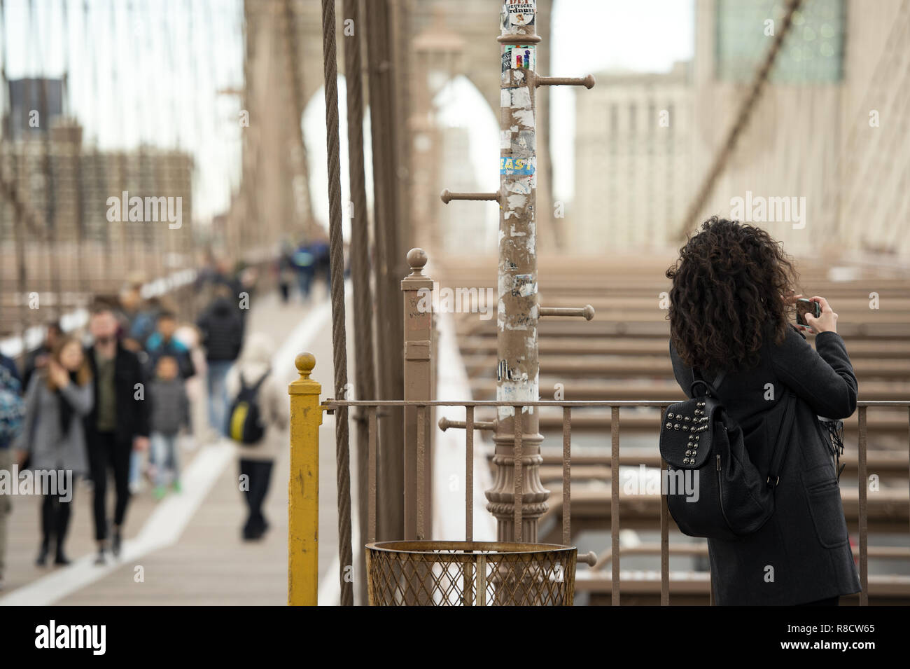 A tourist is taking photo from the famous Brooklyn Bridge in Manhattan ...