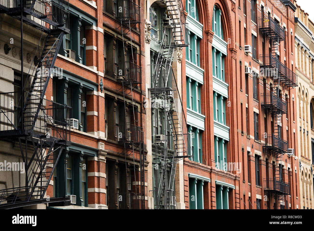 Close-up view of New York City style apartment buildings with emergency stairs along Mott Street in Chinatown neighborhood of Manhattan. Stock Photo