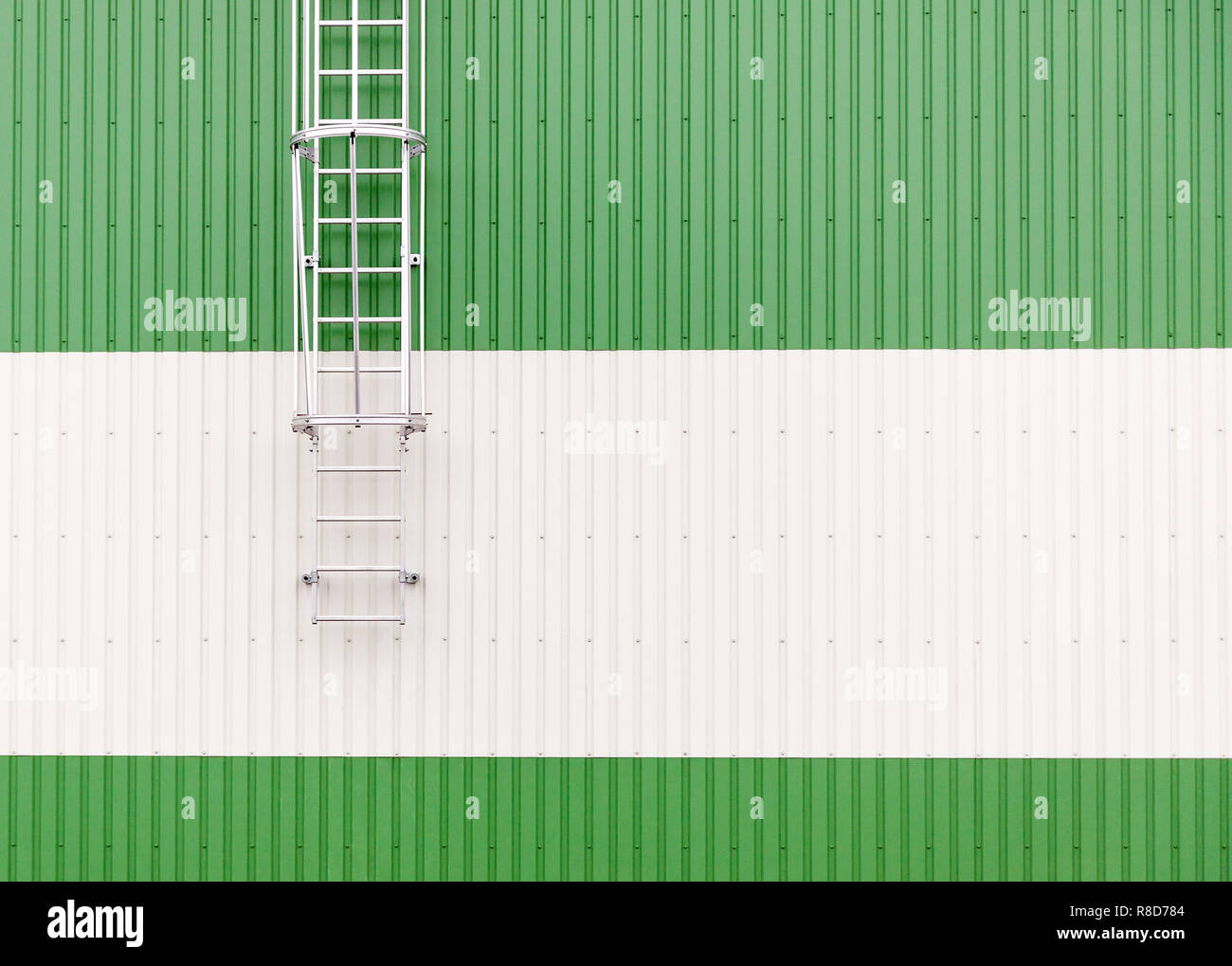 Industrial warehouse wall with metal ladder. Abstract minimalist picture with copy space on the right Stock Photo