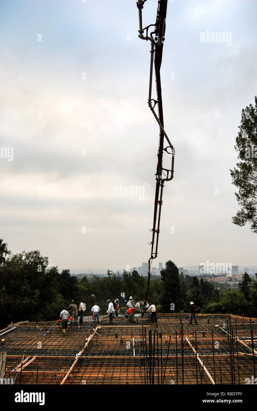Pumping concrete on a new hillside foundation Stock Photo Alamy