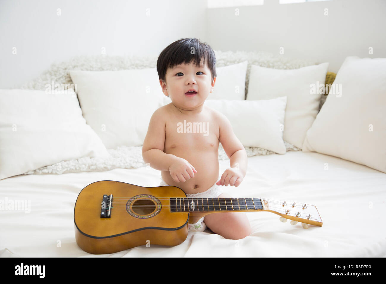 Little two cute babies photo. Baby wearing diaper in white bedroom. 267 Stock Photo