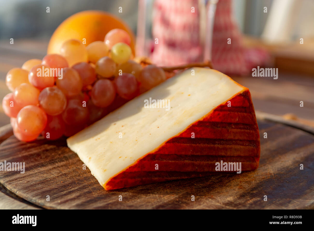 Spanish goat milk cheese with paprika coating and ripe pink table