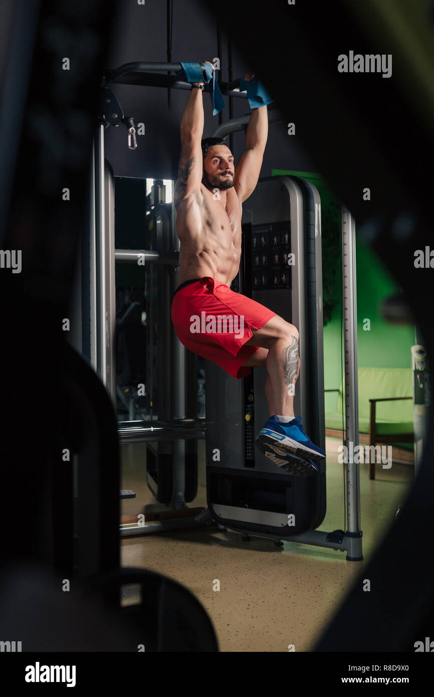Strong man in the gym doing abs exercise Stock Photo