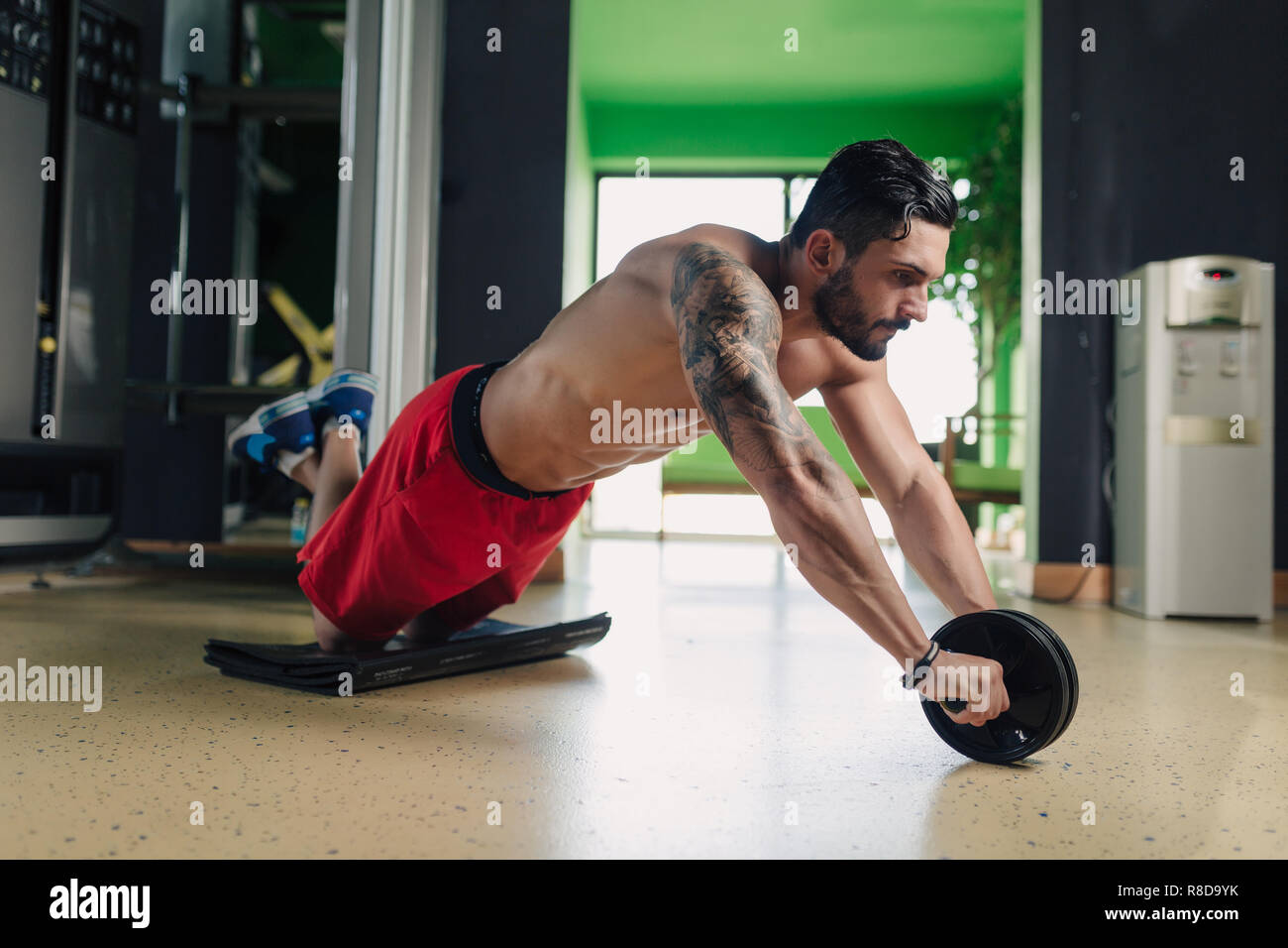 Strong man in the gym doing abs exercise Stock Photo