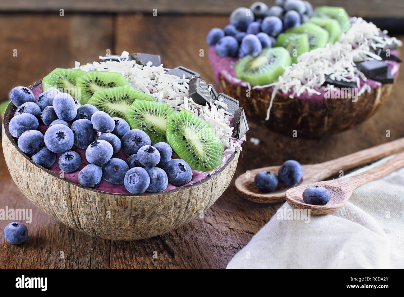 Açai smoothie bowl with fresh kiwi, frozen blueberries, organic coconut