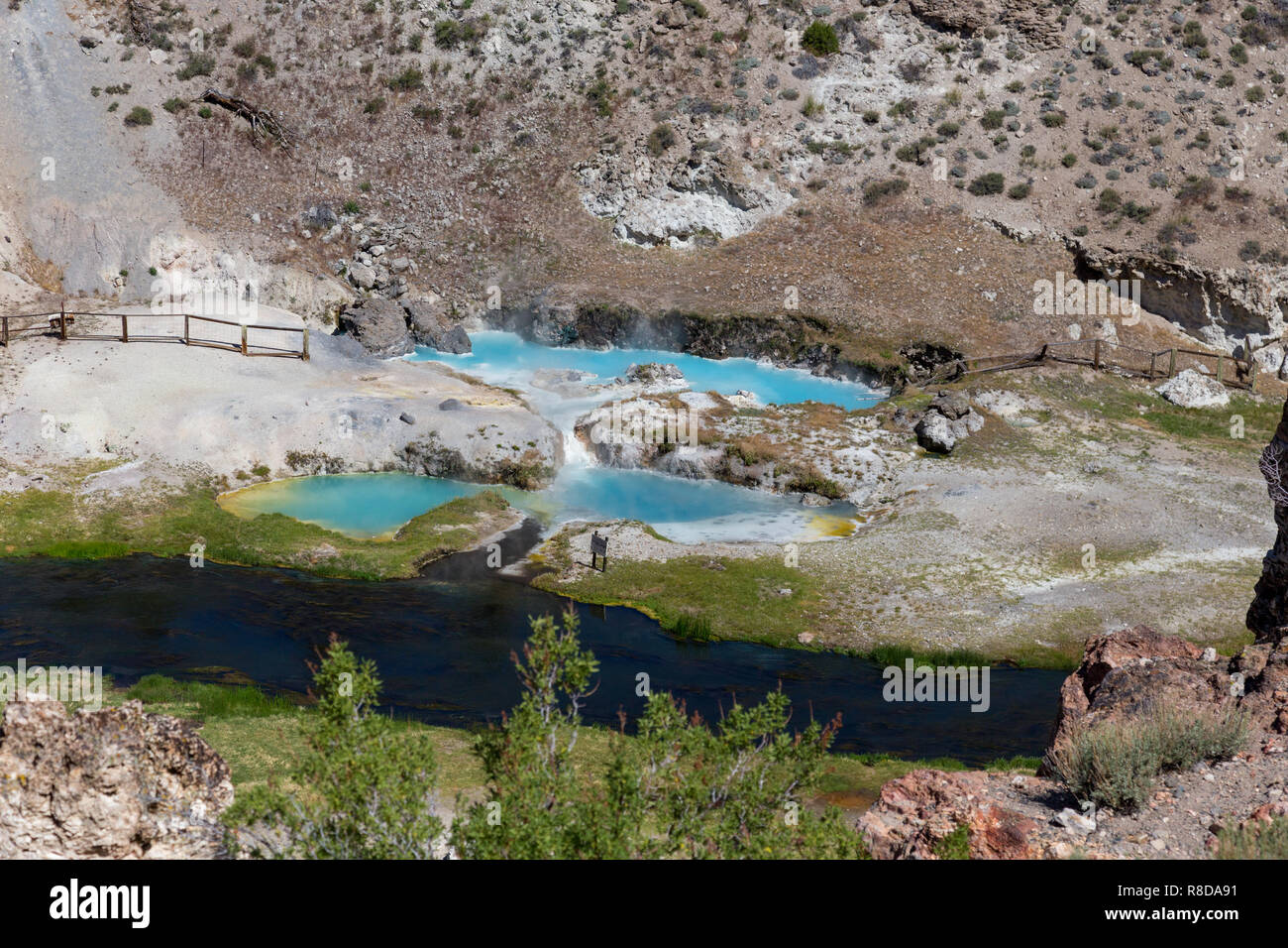 Hot Creek has dozens of natural hot springs bubbling up within the rocky walls of a river gorge and in the shadows of towering Eastern Sierra mountain Stock Photo