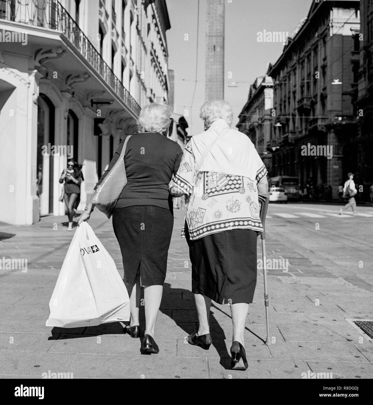 two old ladies walking in the sun , Bologna, italy . made by rolleiflex Stock Photo