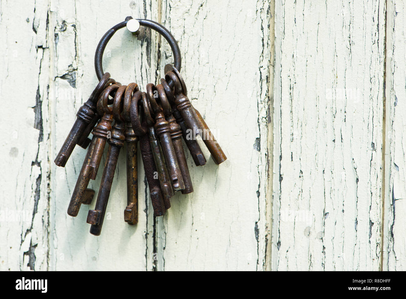 Old keyring with many keys on wooden background Stock Photo - Alamy