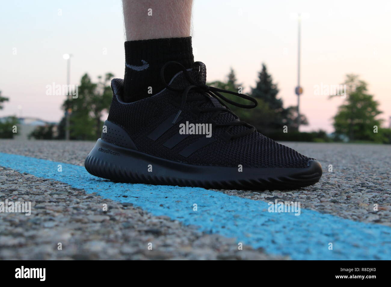 Adidas Cloudfoam Ultimate Athletic Shoes on Pavement Stock Photo - Alamy
