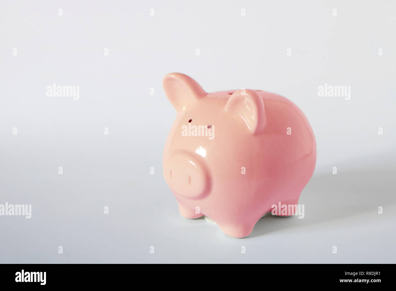 Photo image concept of saving money, financial wealth management, cute pink piggy bank on white background with some empty space Stock Photo