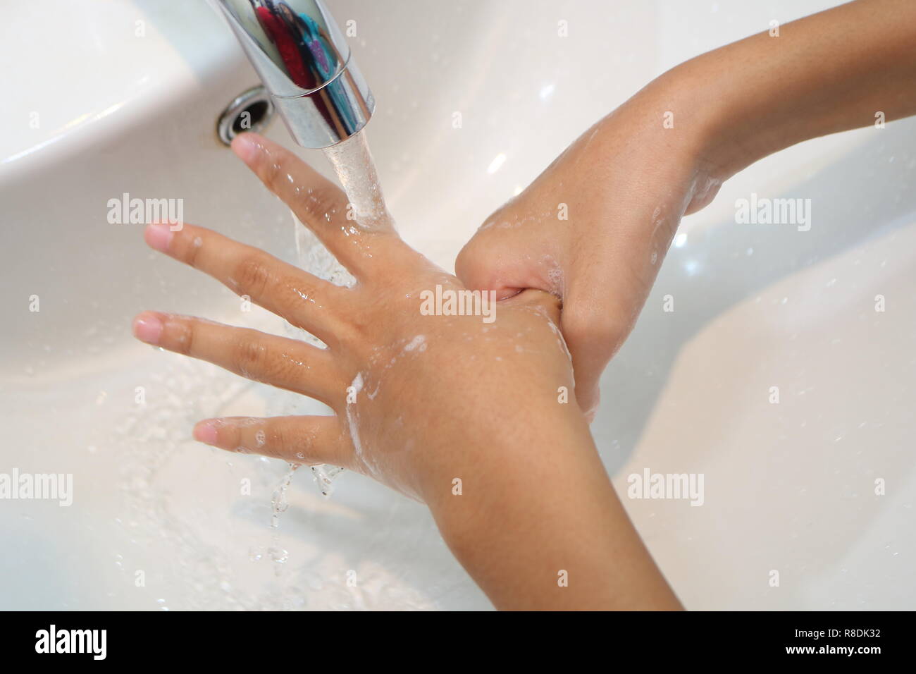 Close up picture of little girls palm when doing hand wash Stock Photo