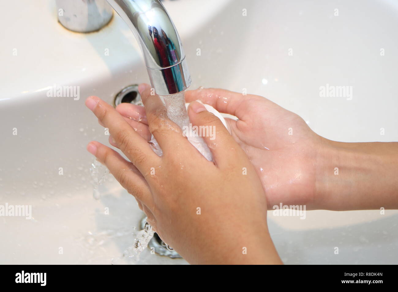 Close up picture of little girls palm when doing hand wash Stock Photo