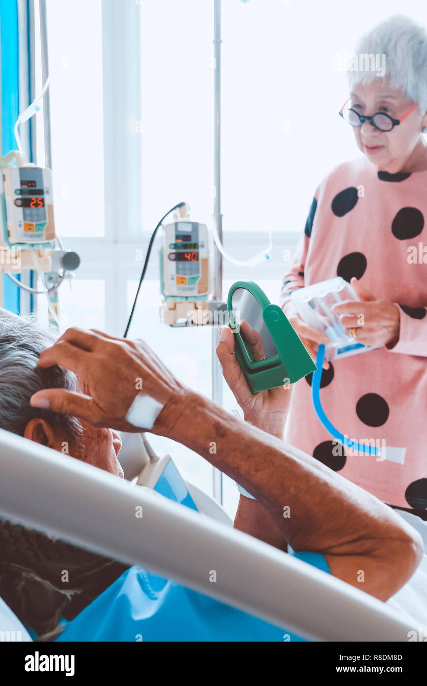 Elderly patients relax in hospital bed Stock Photo Alamy