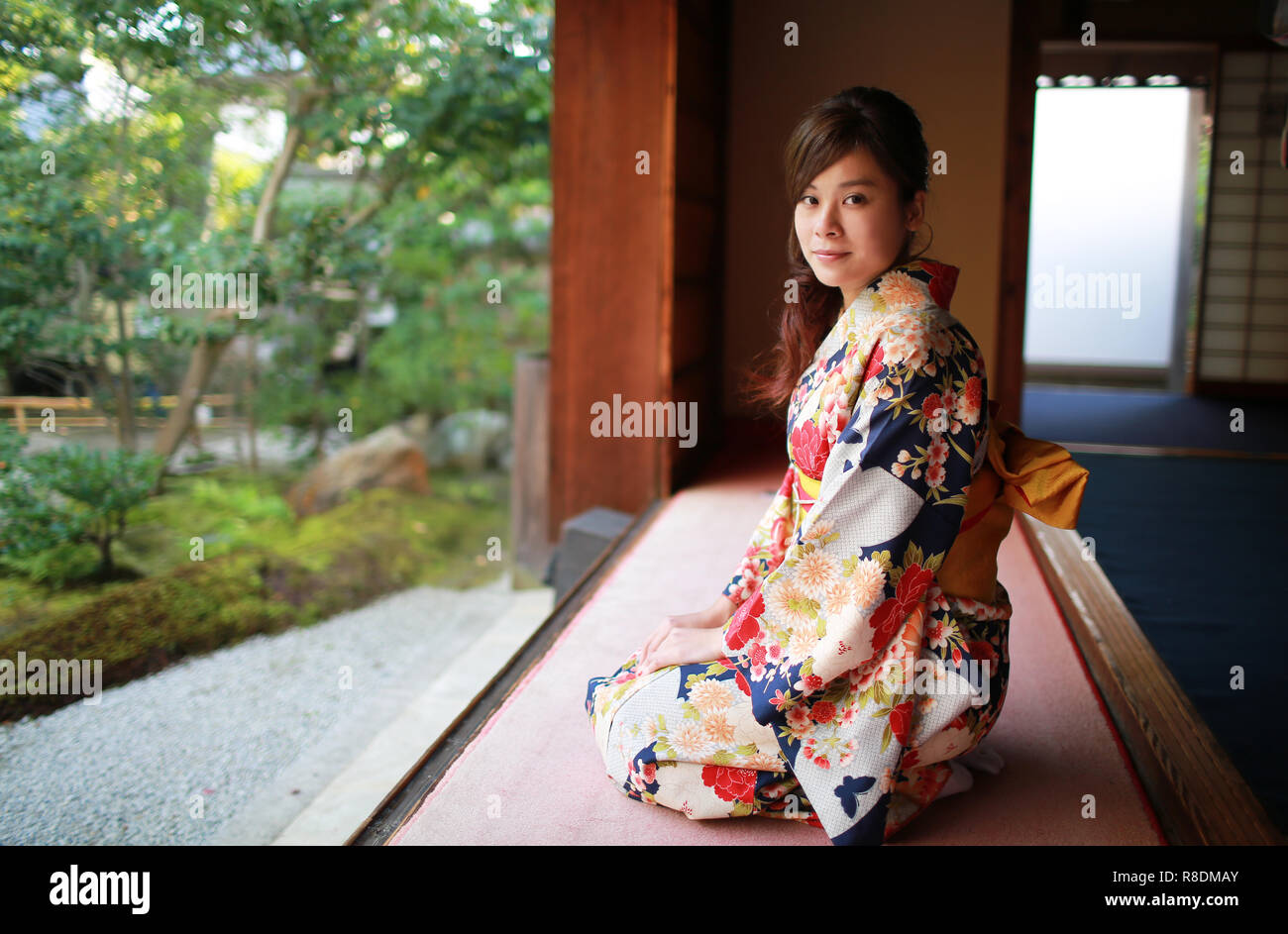 kimono dressing sit in front of the kyoto garden Stock Photo