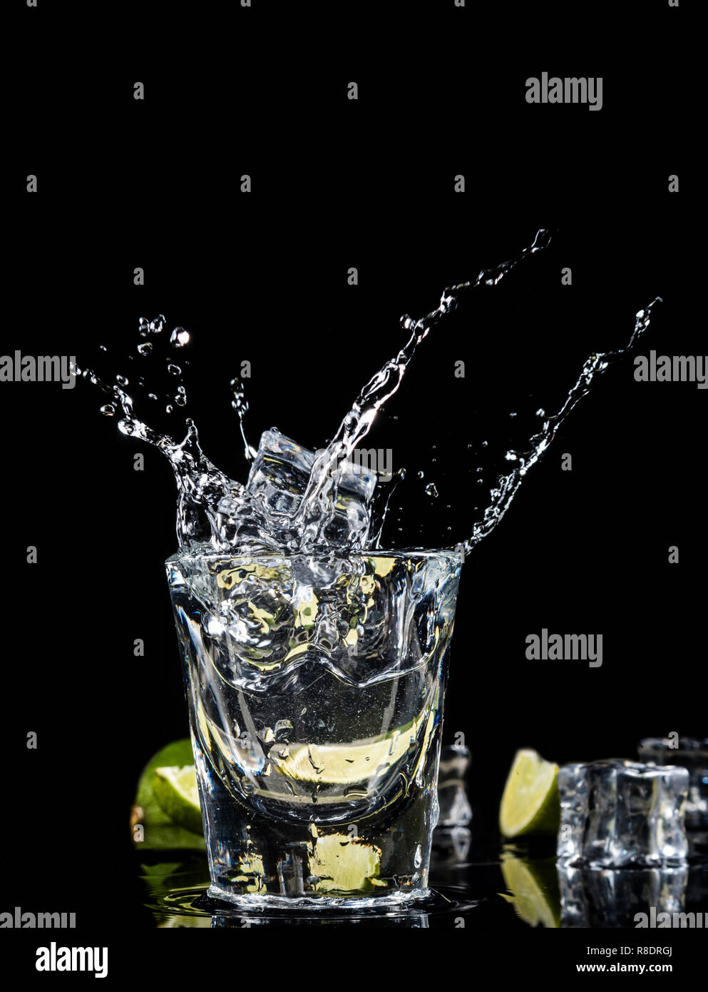 Mexican traditional Tequila splash ice cube on black background with