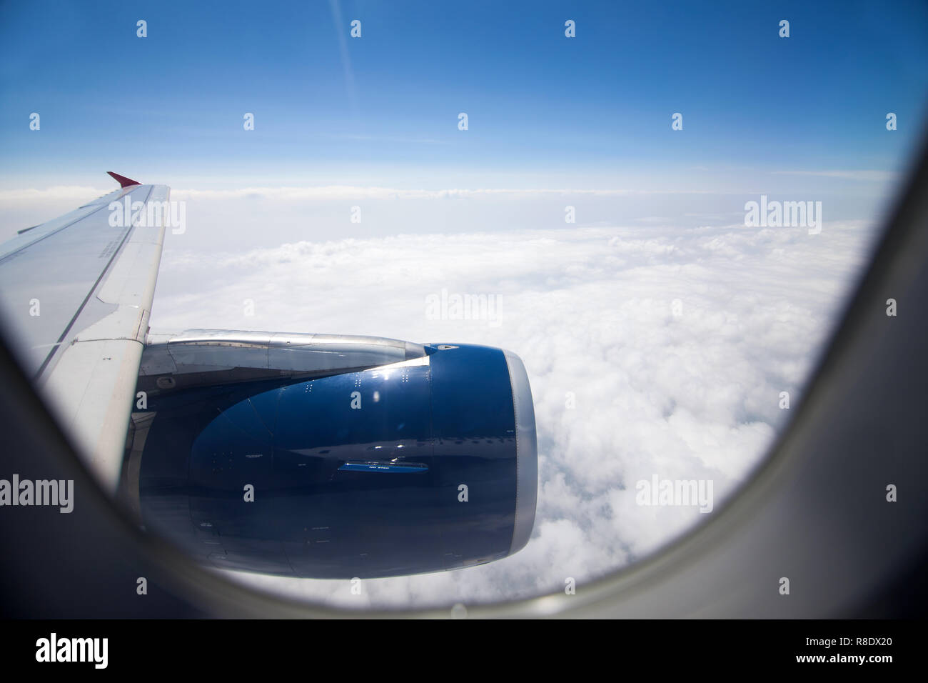 Looking to airplane engine through the window during flight from inside of plane Stock Photo