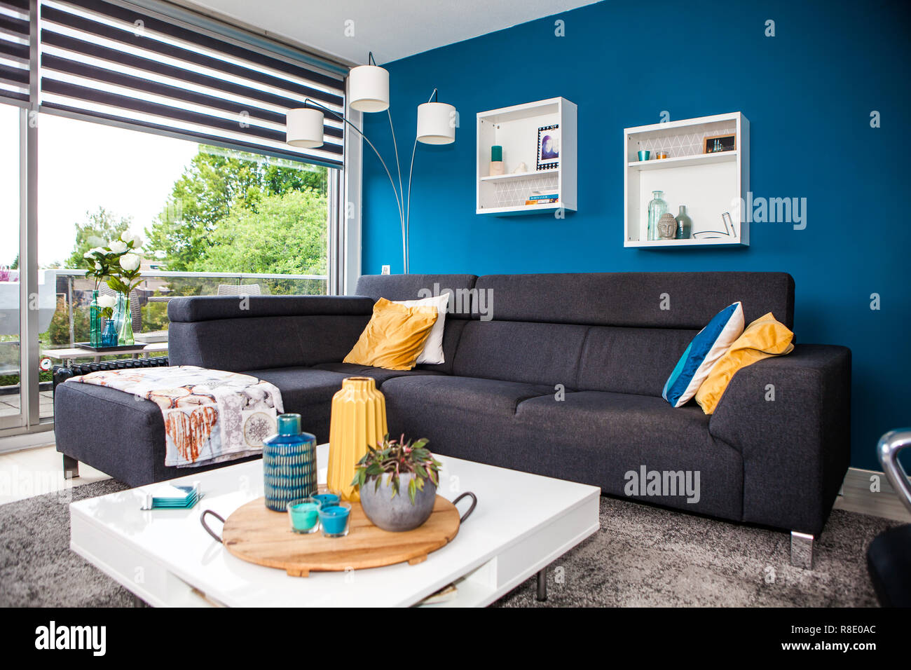 Modern living room design with sofa and yellow and blue colors. Stock Photo