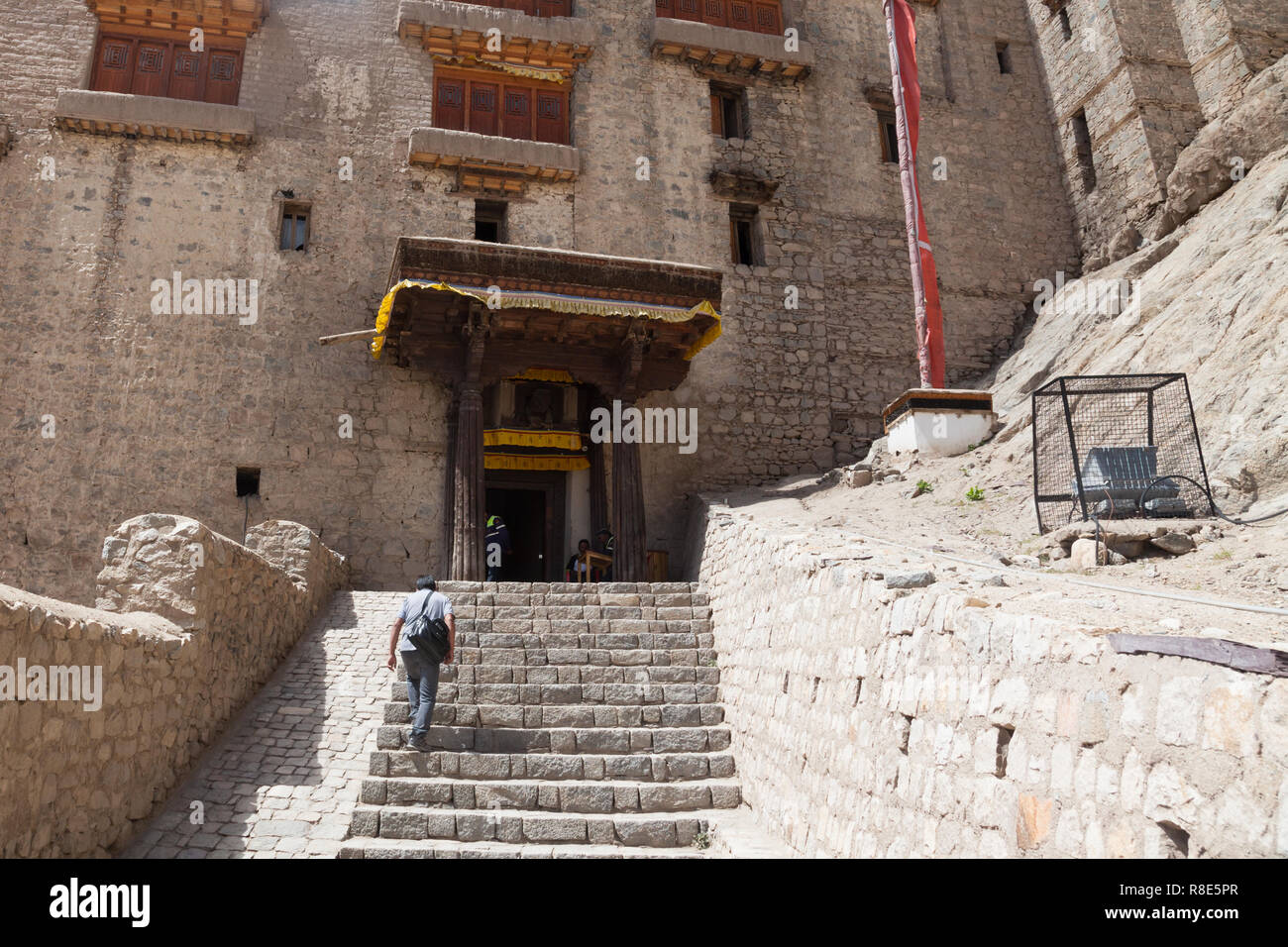 Man with a bag going towards the entrance to Leh Palace, Leh, Ladakh, Jammu and Kashmir, India Stock Photo