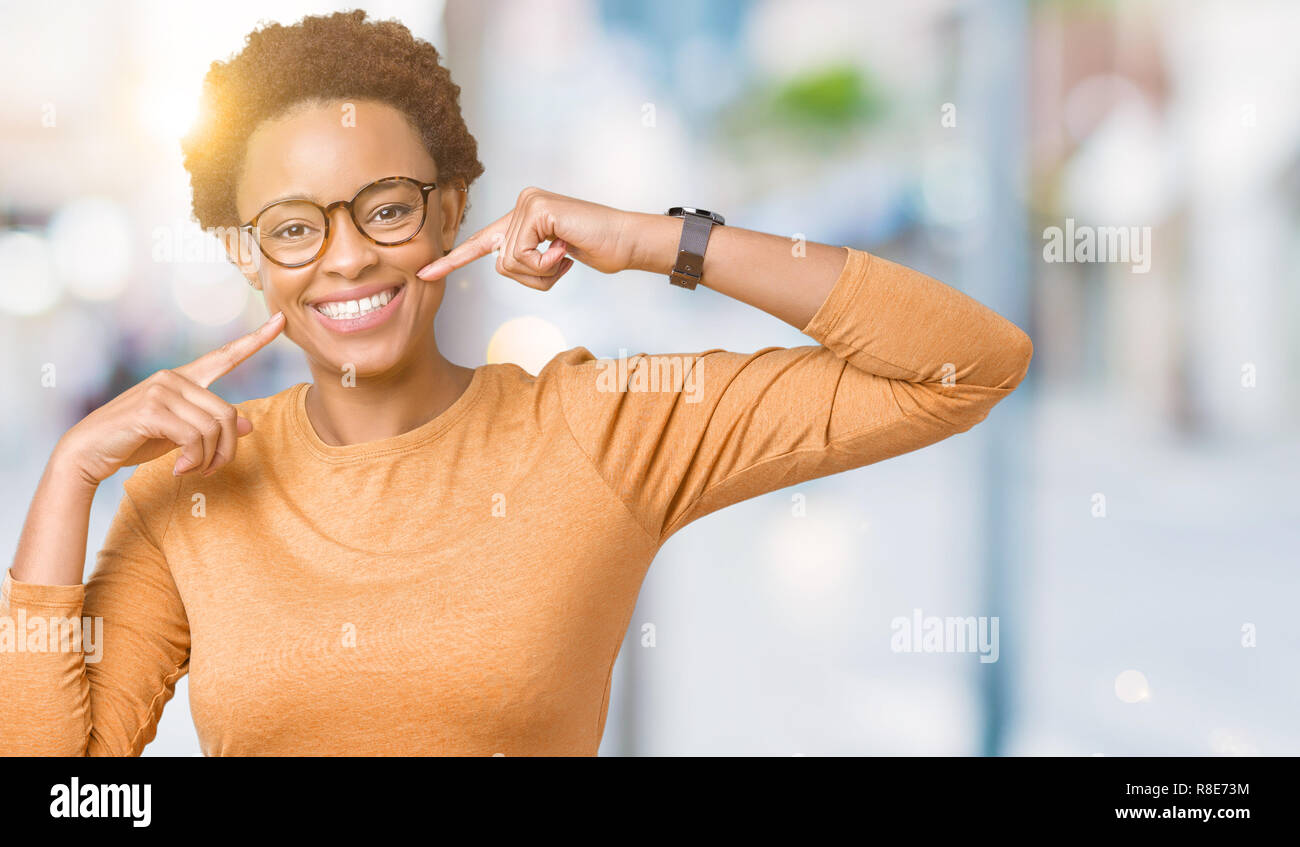Young beautiful african american woman wearing glasses over isolated ...