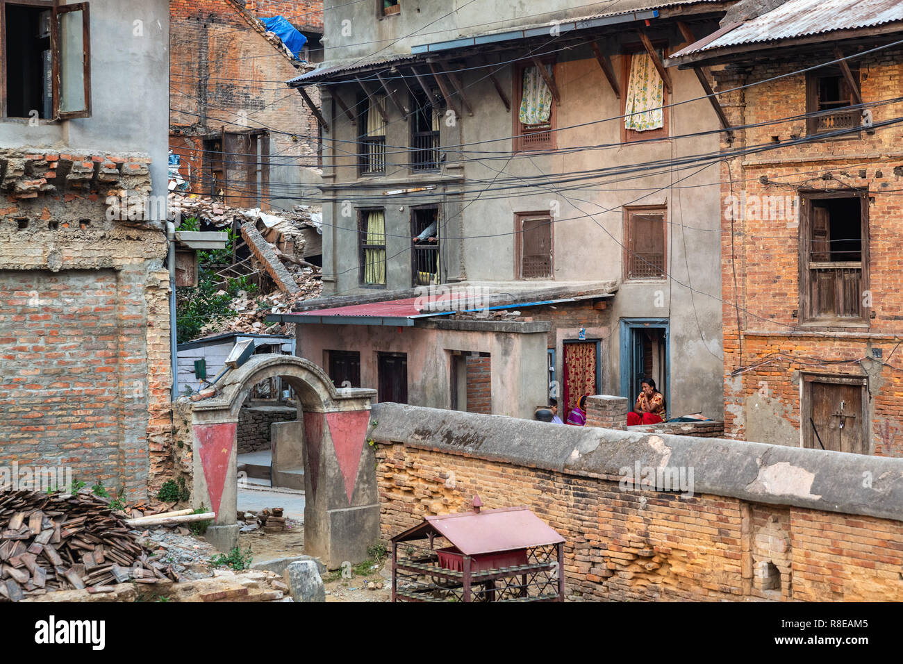 Local woman sitting on porch with her friends in Patan, Lalitpur,  Nepal. Stock Photo