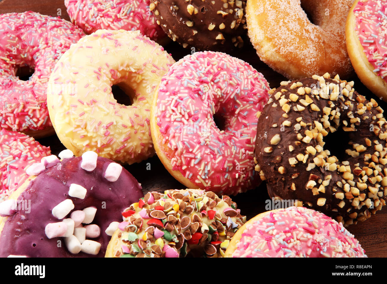assorted donuts with chocolate frosted, pink glazed and sprinkles ...