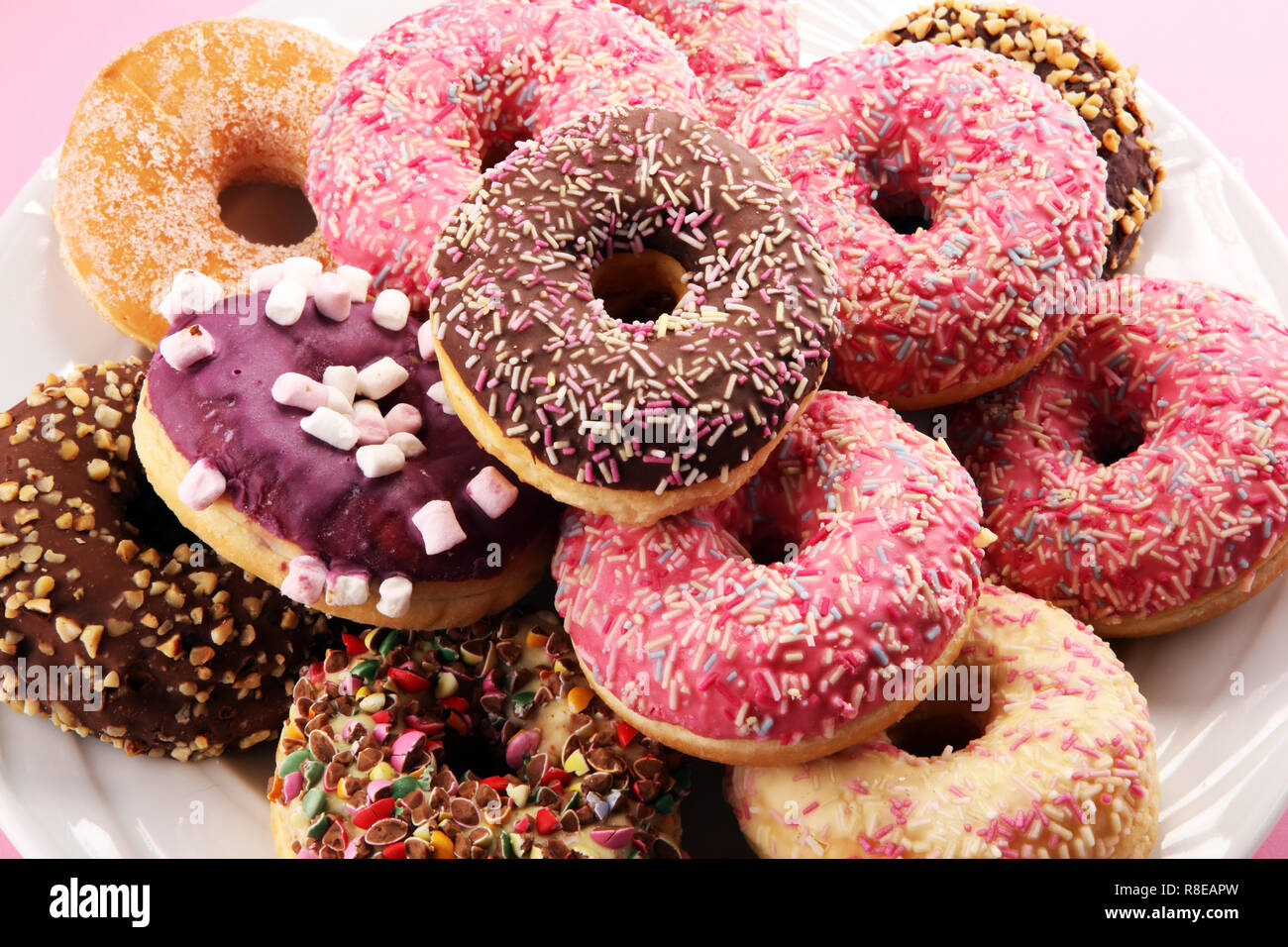 assorted donuts with chocolate frosted, pink glazed and sprinkles ...