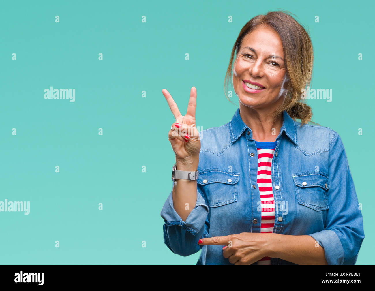 Middle age senior hispanic woman over isolated background smiling with ...